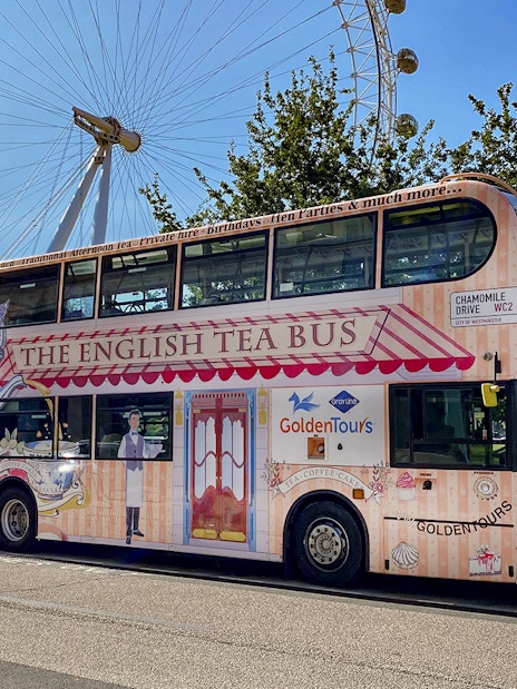 Afternoon Tea Bus parked near the London Eye, offering a unique sightseeing experience.