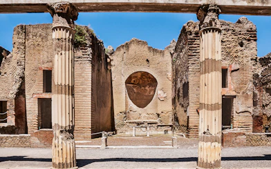 Ancient columns and walls at Herculaneum ruins in Italy.