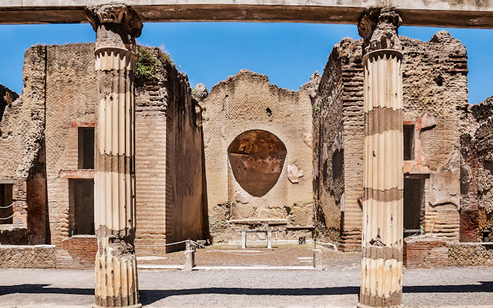 Ancient columns and walls at Herculaneum ruins in Italy.