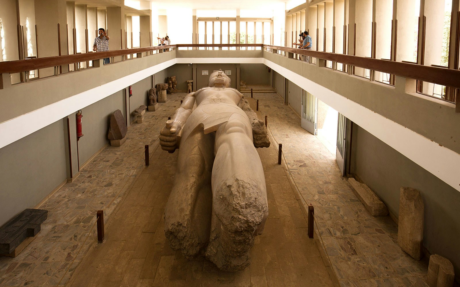 Tourists view the colossal statue of King Ramses II at the open-air museum in Memphis, Egypt.