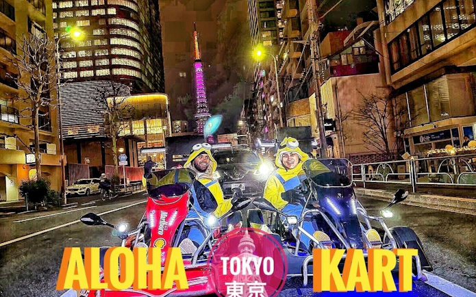 Go-kart riders in Minion costumes driving near Tokyo Tower at night.