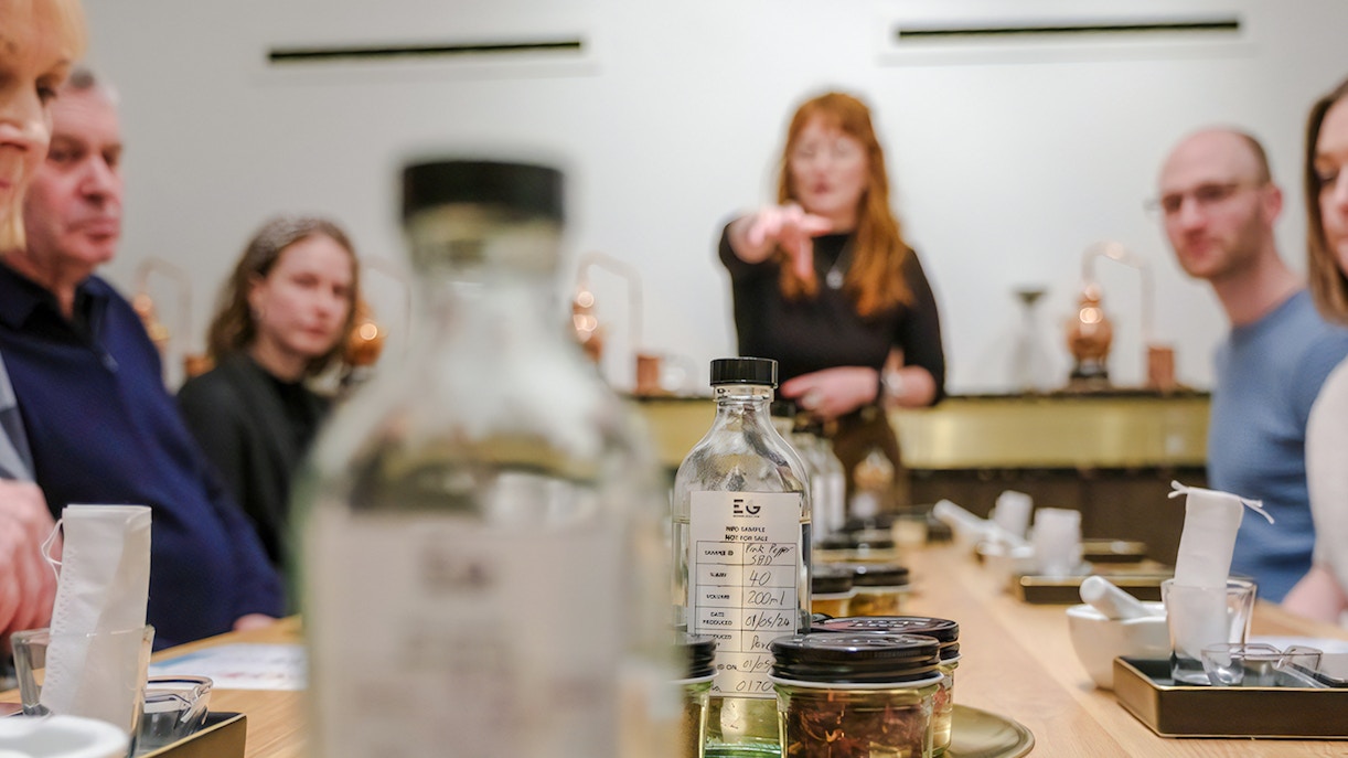 Gin distillery tour in Edinburgh with copper stills and gin bottles.
