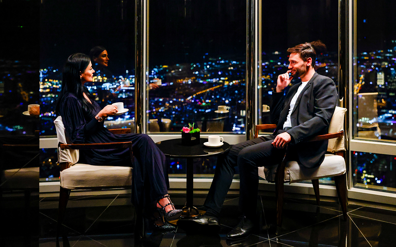 Couple enjoying night view from Burj Khalifa Level 152 Lounge.