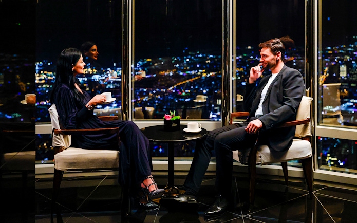 Couple enjoying night view from Burj Khalifa Level 152 Lounge.