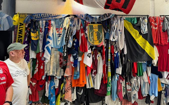 Soccer jerseys and memorabilia displayed at Casa de D10S on the Maradona Walking Tour in La Paternal, Buenos Aires.