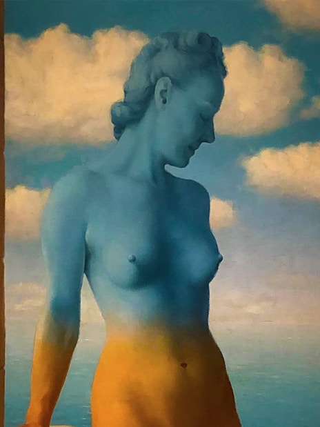 Surreal painting of a blue and orange figure against a cloudy sky at Peggy Guggenheim Collection.