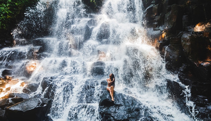 Woman at Kanto waterfall in Bali - Mount Batur