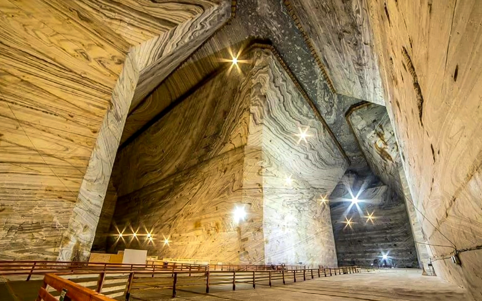 Guests exploring the vast chambers of Slanic Salt Mine in Romania.