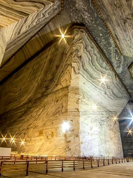 Guests exploring the vast chambers of Slanic Salt Mine in Romania.