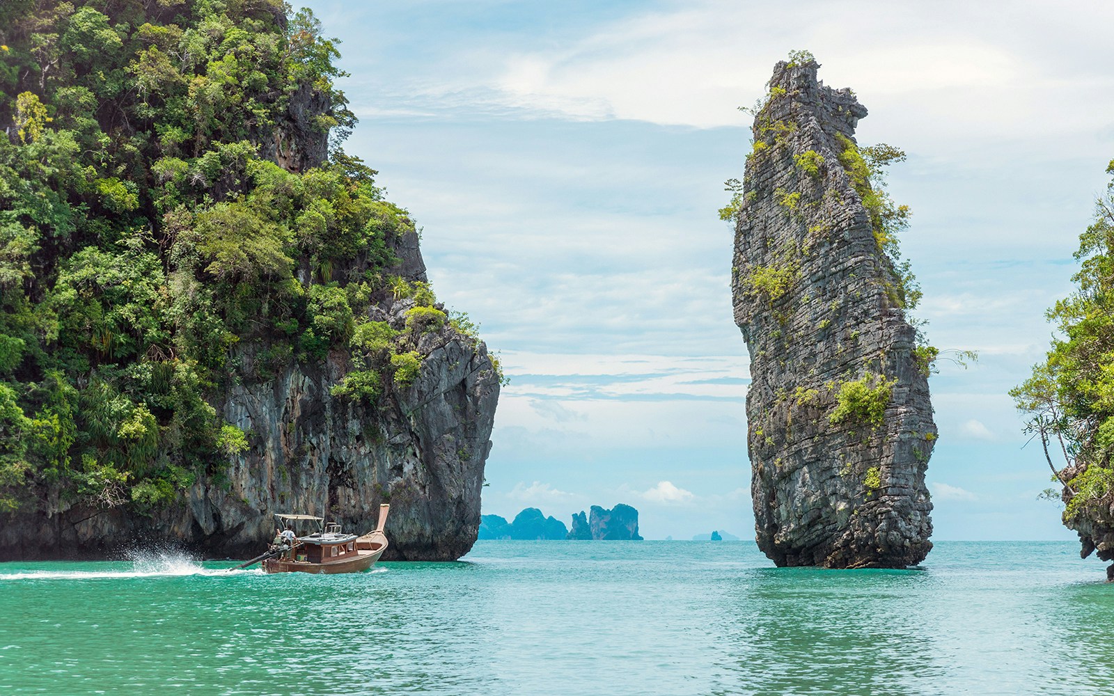 Phang Nga Bay limestone cliffs and emerald waters, Phuket boat tour.