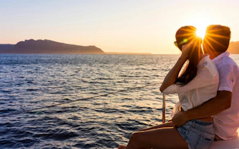Tourists enjoying a sunset cruise on a classic boat in Ibiza.