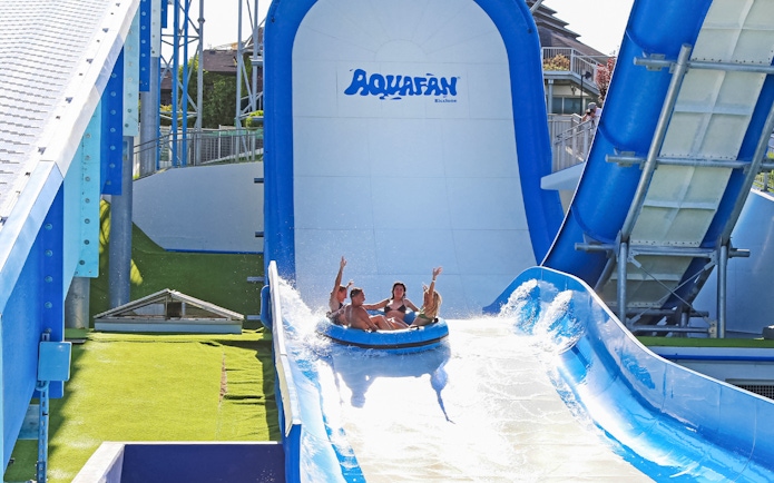 Visitors enjoying a water slide at Aquafan Water Park, Riccione.