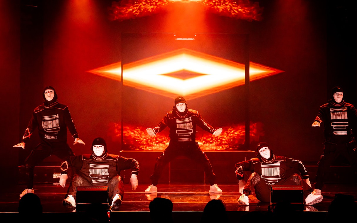 Dancers in masks performing at Jabbawockeez show, Las Vegas stage.
