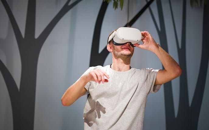 Man using VR headset at Foundation Louis Vuitton exhibit.