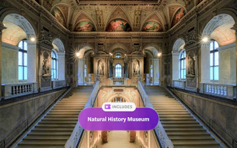 Staircase inside Natural History Museum Vienna with ornate ceilings and statues.