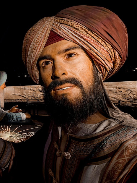 Three historical figures in traditional attire at Expo City Dubai exhibit.