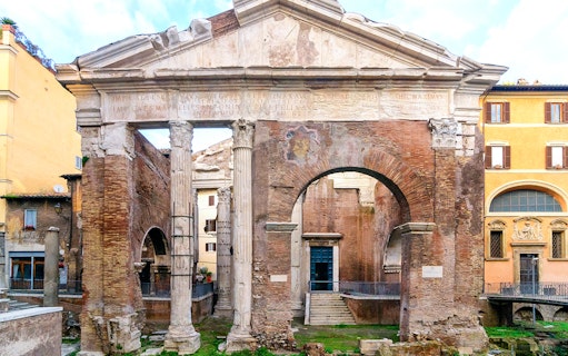 Portico di Ottavia ancient Roman ruins in Rome, Italy, featuring stone columns and archway.
