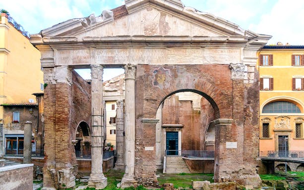 Portico di Ottavia ancient Roman ruins in Rome, Italy, featuring stone columns and archway.