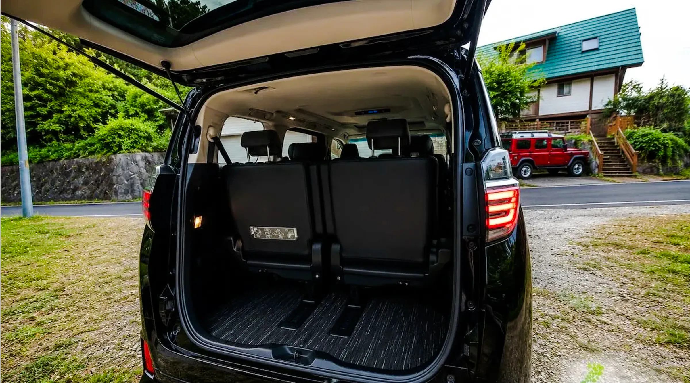 Open trunk of a private transfer vehicle at Haneda Airport for Tokyo city transport.