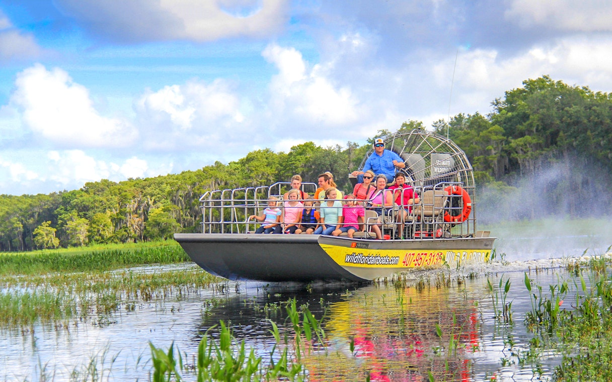 Guests on an airboat tour enjoying the Everglades view.