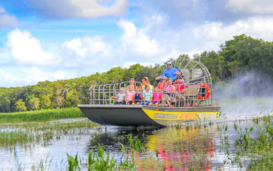Guests on an airboat tour enjoying the Everglades view.