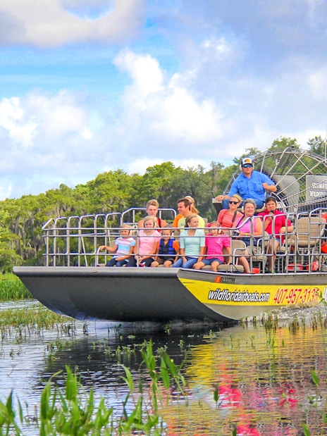 Guests on an airboat tour enjoying the Everglades view.