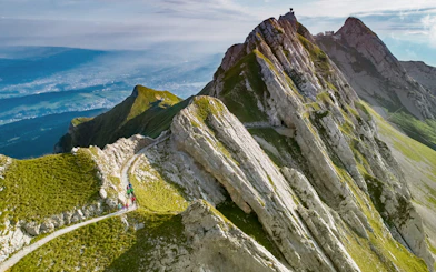 Hikers on a trail along the rocky peaks of Mount Pilatus, Lucerne.