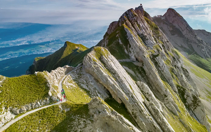 Hikers on a trail along the rocky peaks of Mount Pilatus, Lucerne.