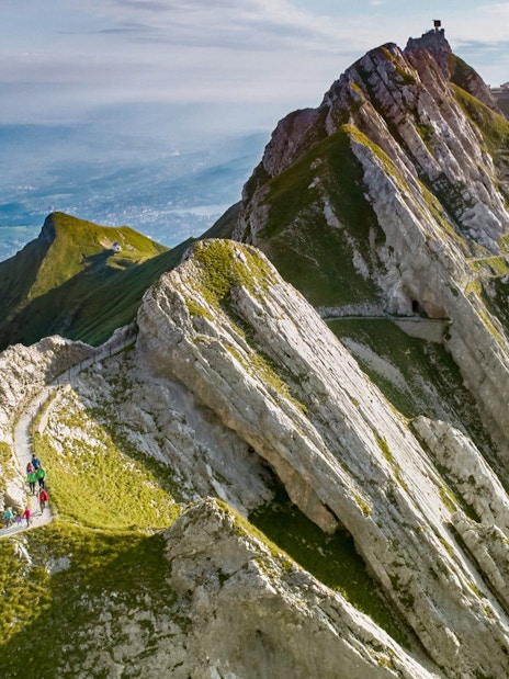 Hikers on a trail along the rocky peaks of Mount Pilatus, Lucerne.