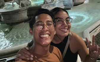 Couple smiling at Trevi Fountain during Ghosts of Rome city exploration game.