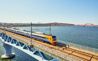 AREX Express train crossing a bridge over a river in Seoul, South Korea.