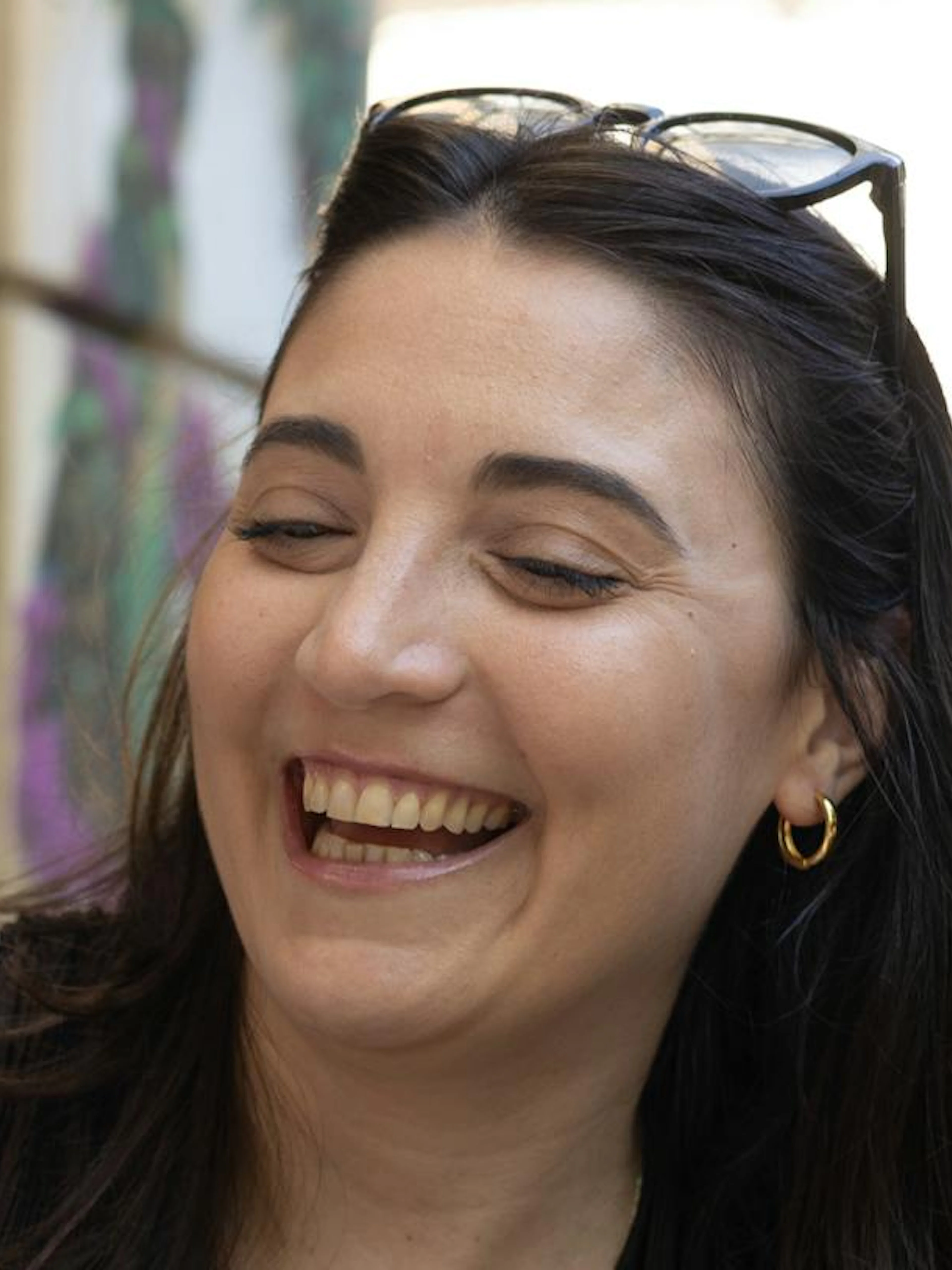Smiling person enjoying food during Athens evening food tour.