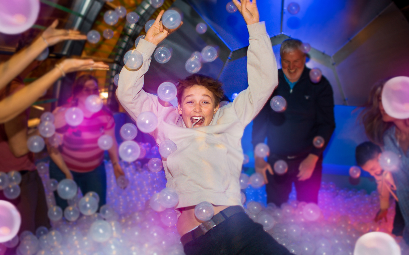 Person enjoying a ball pit experience in Copenhagen attraction.