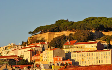 Lisbon's Alfama district with São Jorge Castle viewed from the Tagus River.