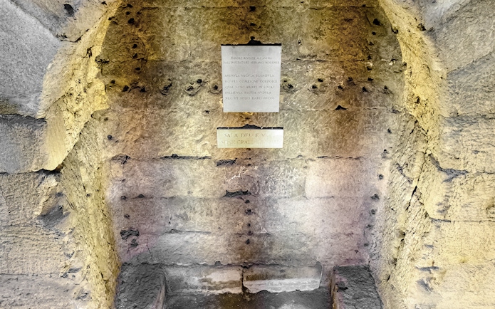 Castel Sant'Angelo Urn Room stone wall with Latin inscriptions.