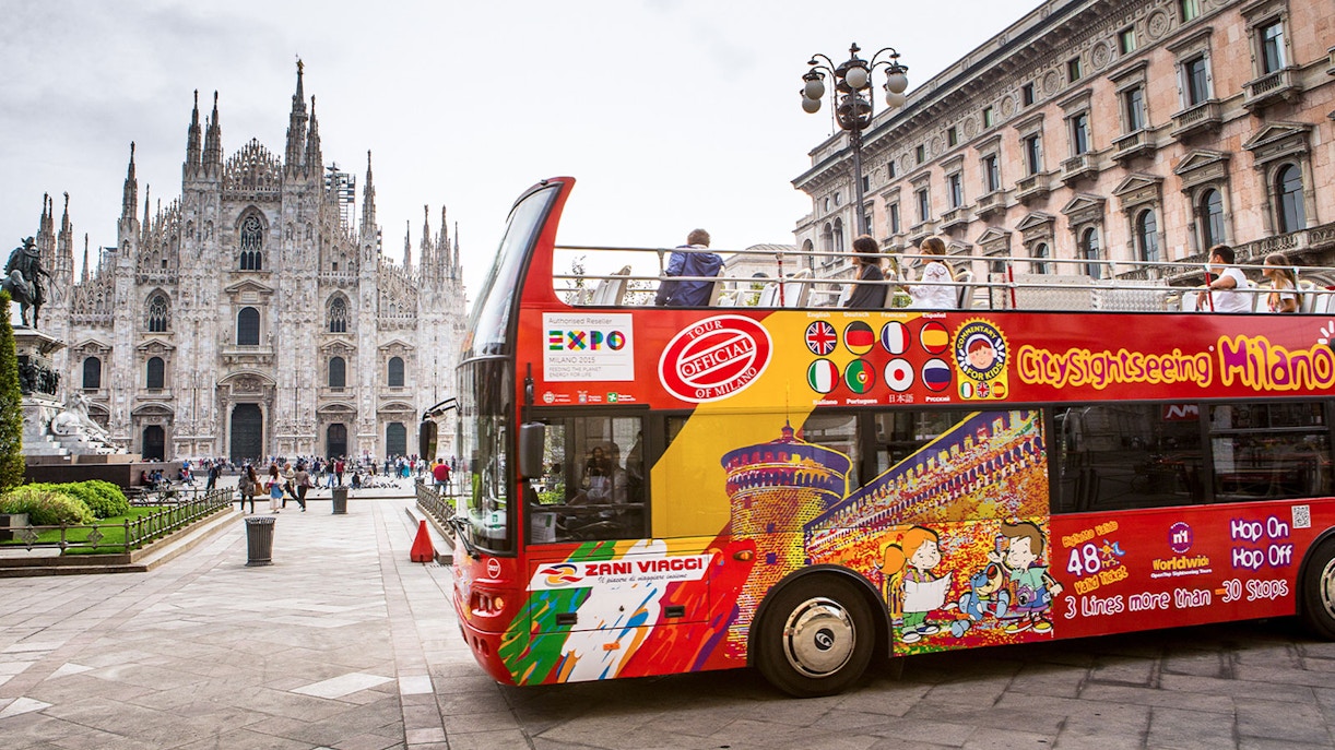 Milan city sightseeing bus with Duomo in the background