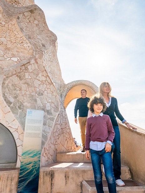 Family exploring Casa Mila Warrior Rooftop in Barcelona.