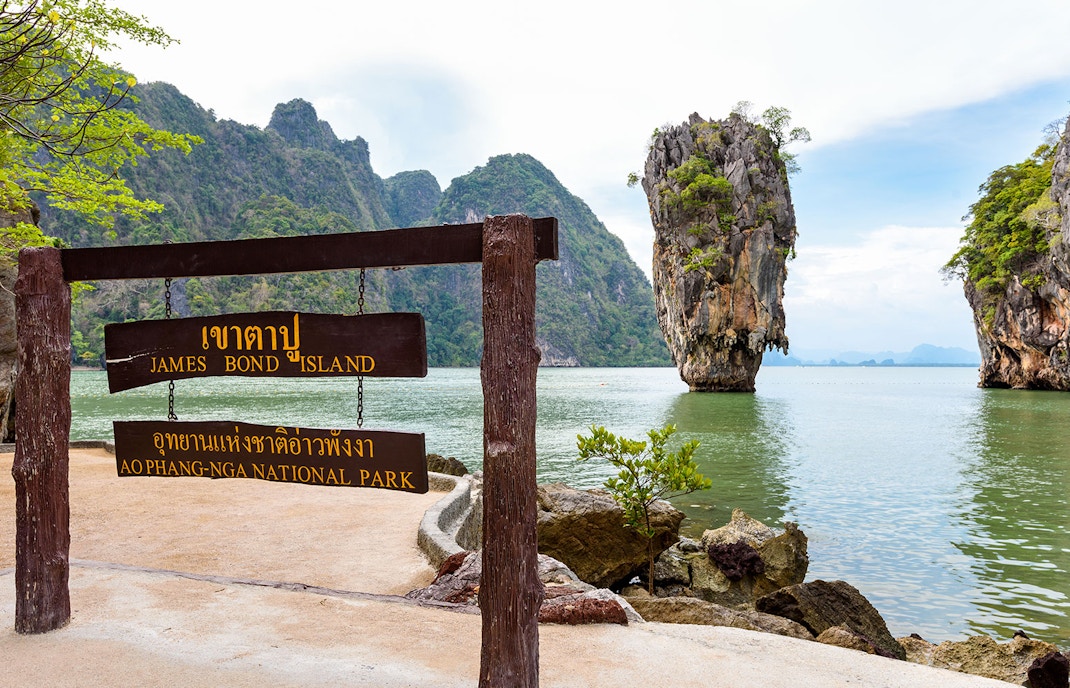 James Bond Island sign with limestone cliffs in Phang Nga Bay, Thailand.