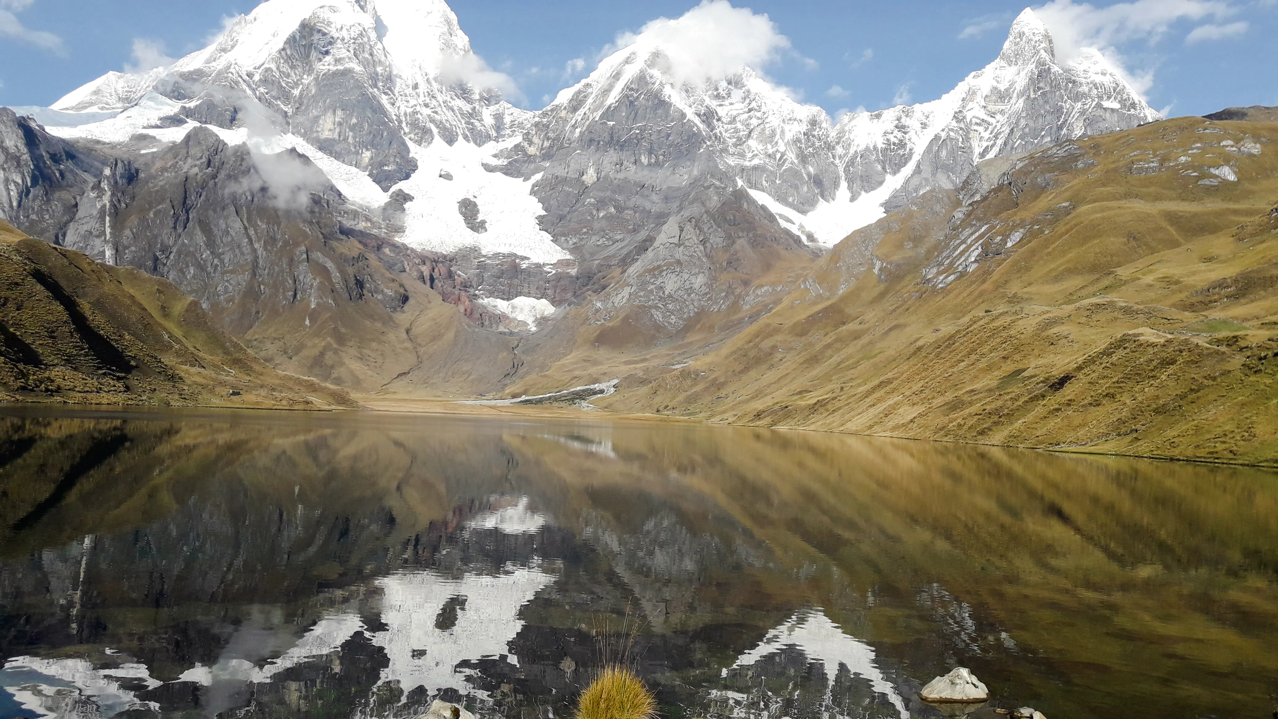 Snow-capped peaks reflected in a lake on the Huayhuash Trek, Peru.