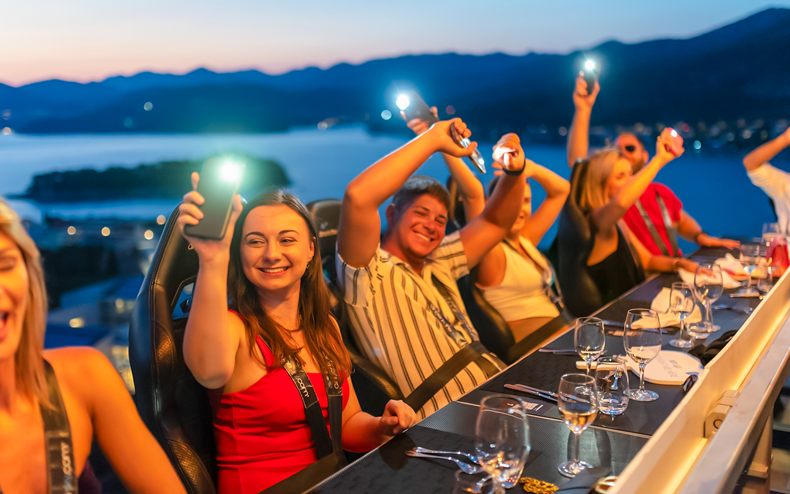 Guests dining at Dinner in the Sky with a view of Dubrovnik at sunset.