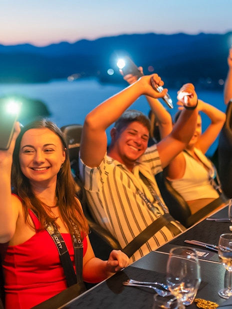 Guests dining at Dinner in the Sky with a view of Dubrovnik at sunset.