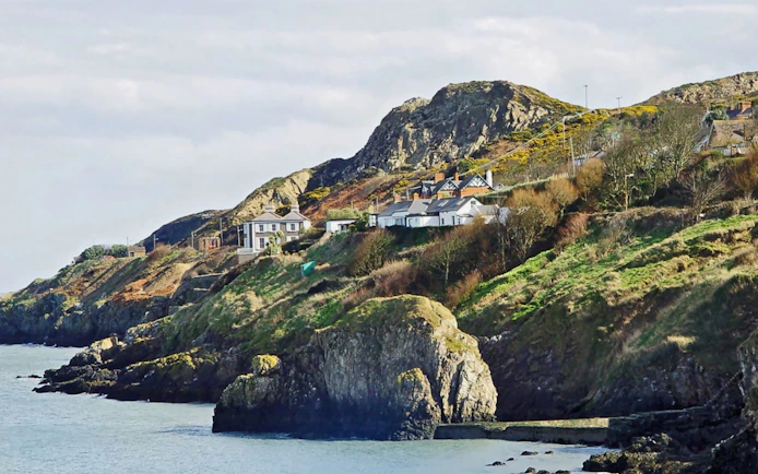 Howth Village coastal cliffs and houses near Dublin.