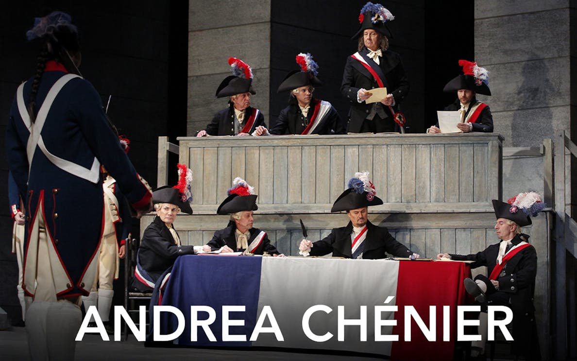 Opera scene from Andrea Chénier with actors in period costumes and tricolor flag.