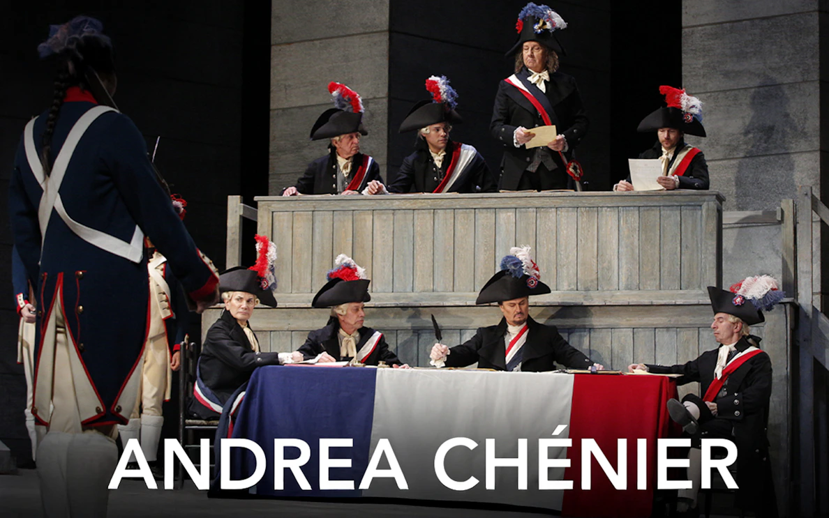Opera scene from Andrea Chénier with actors in period costumes and tricolor flag.