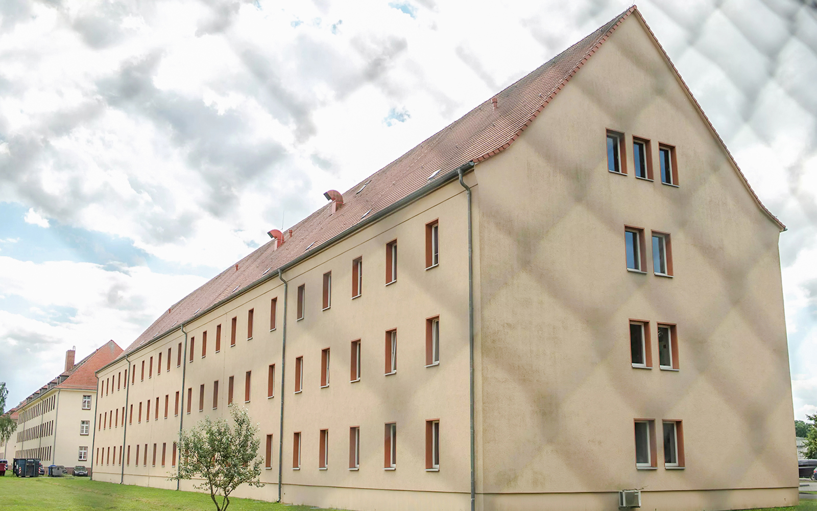Sachsenhausen Concentration Camp Memorial building exterior with cloudy sky.
