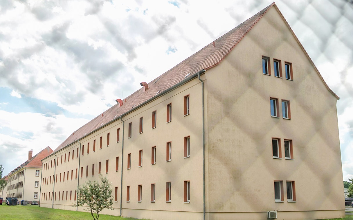 Sachsenhausen Concentration Camp Memorial building exterior with cloudy sky.