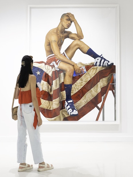 Woman viewing artwork at Moco Museum, Amsterdam.