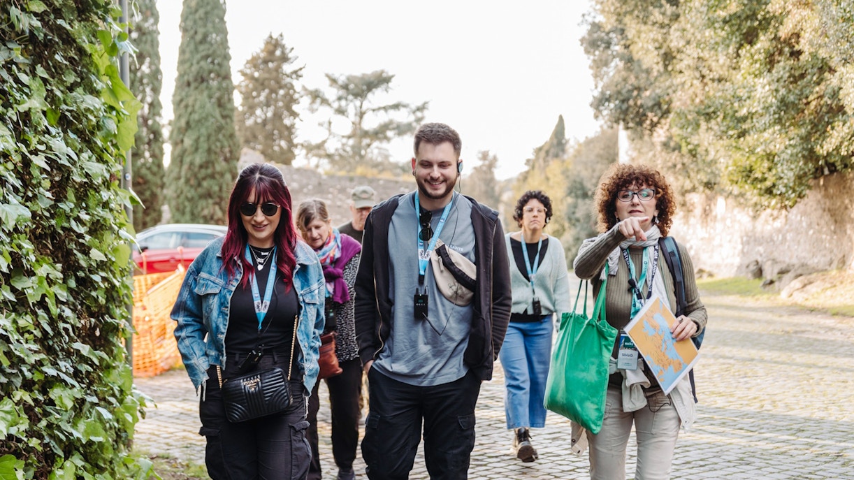 Tour group walking along the Appian Way during the Underground Rome Catacombs Tour.