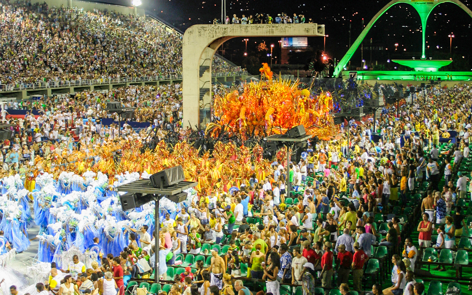 Sambadrome parade with colorful costumes and full grandstands in Rio de Janeiro.