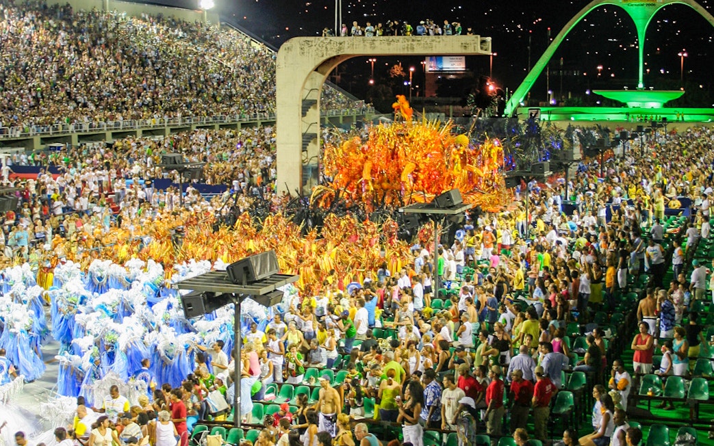 Sambadrome parade with colorful costumes and full grandstands in Rio de Janeiro.